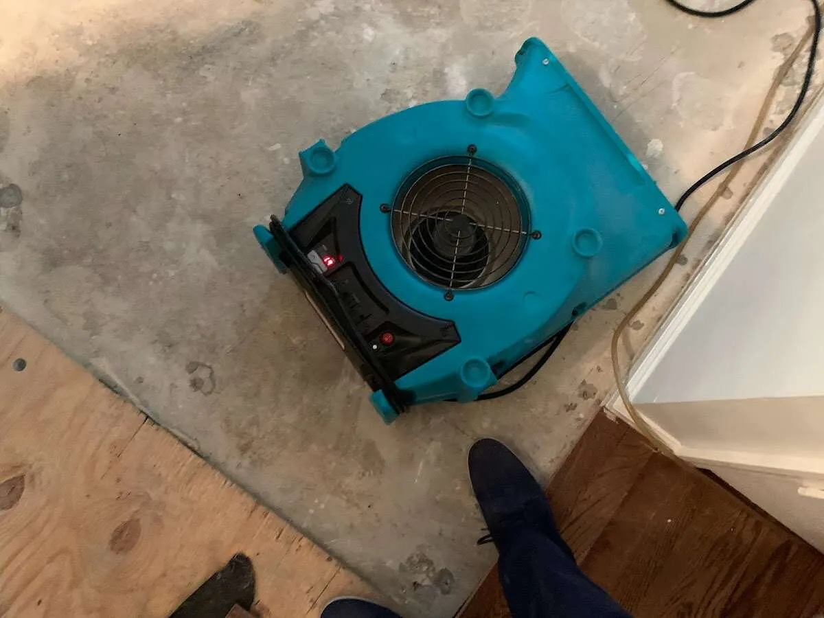 Air mover drying subfloor during Leak Detection & Repair in Spirit Lake